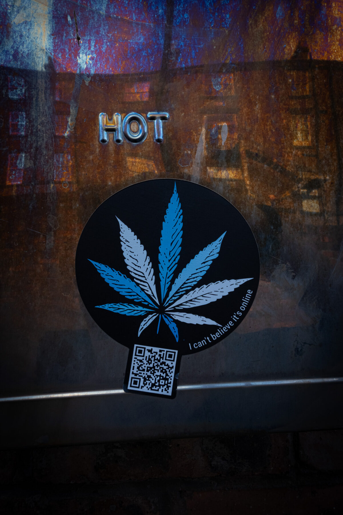 Cannabis leaf sticker on a rusted panel