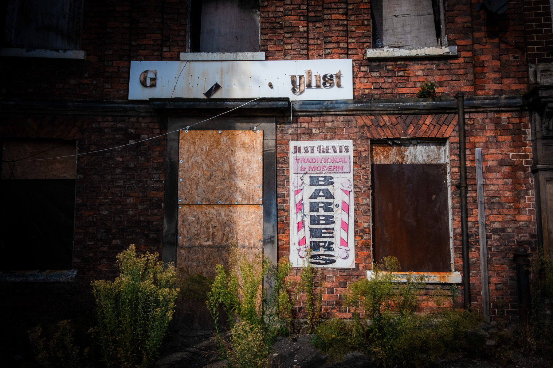 Derelict barber shop with boarded windows