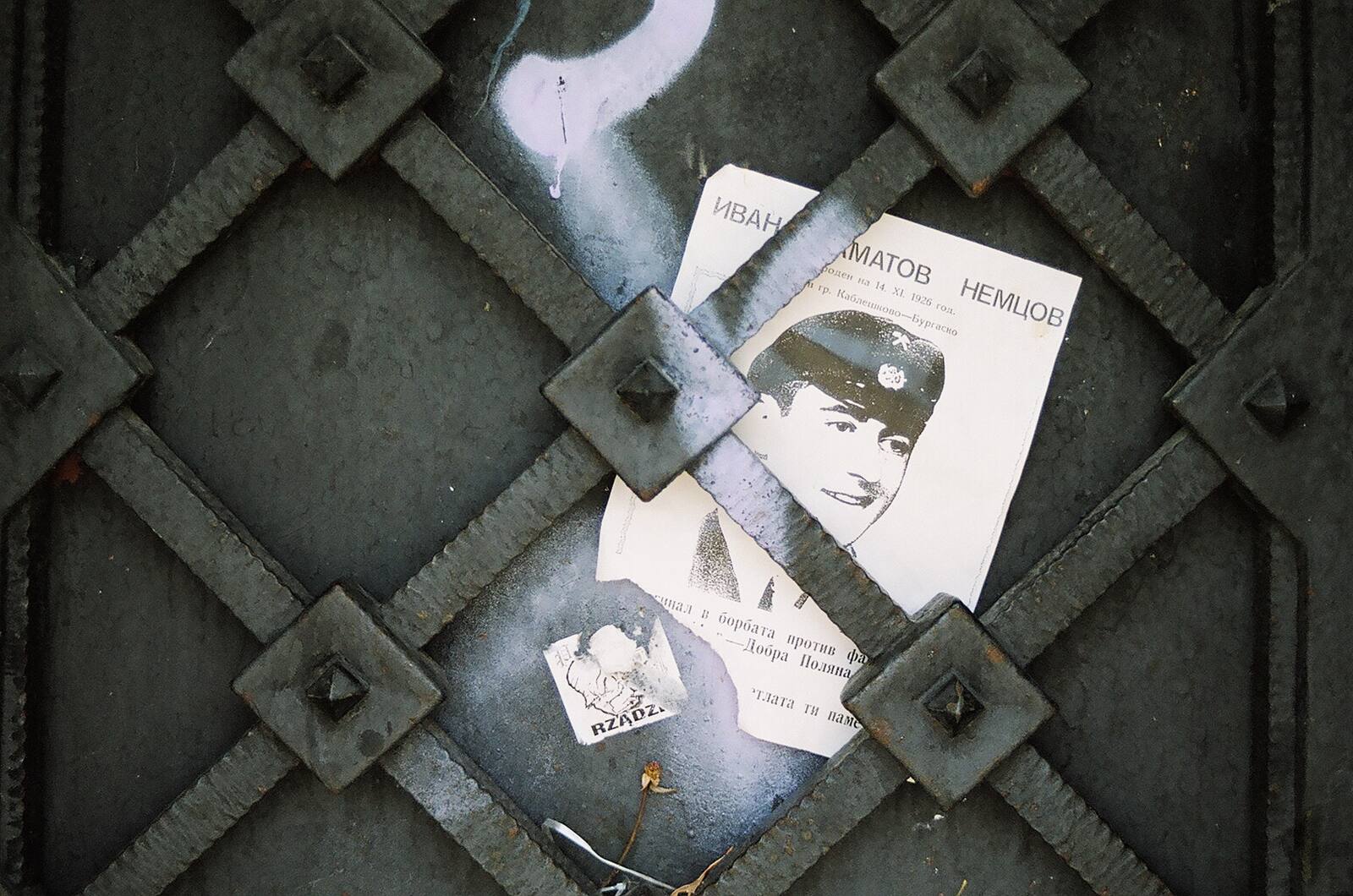 Portrait photograph tucked into iron gate