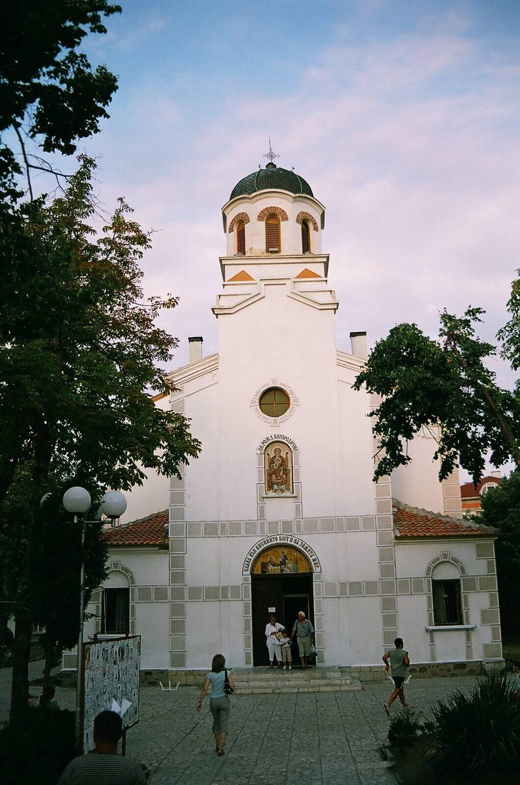 White church tower against the evening sky