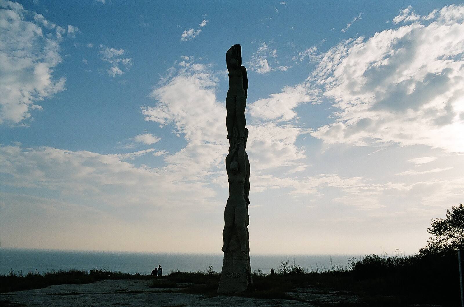 The column — figures stacked like a prayer said upward.
