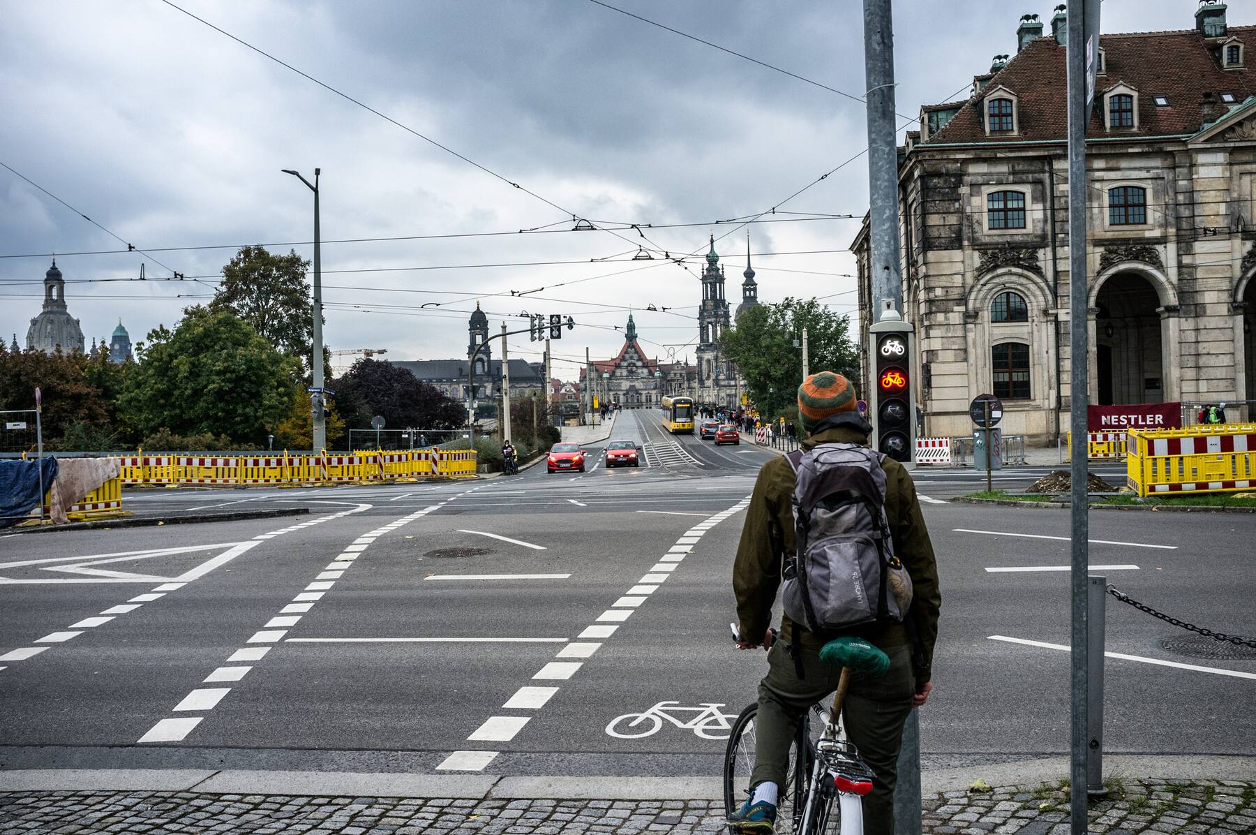 Cyclist waiting at a red light, Hofkirche in the distance