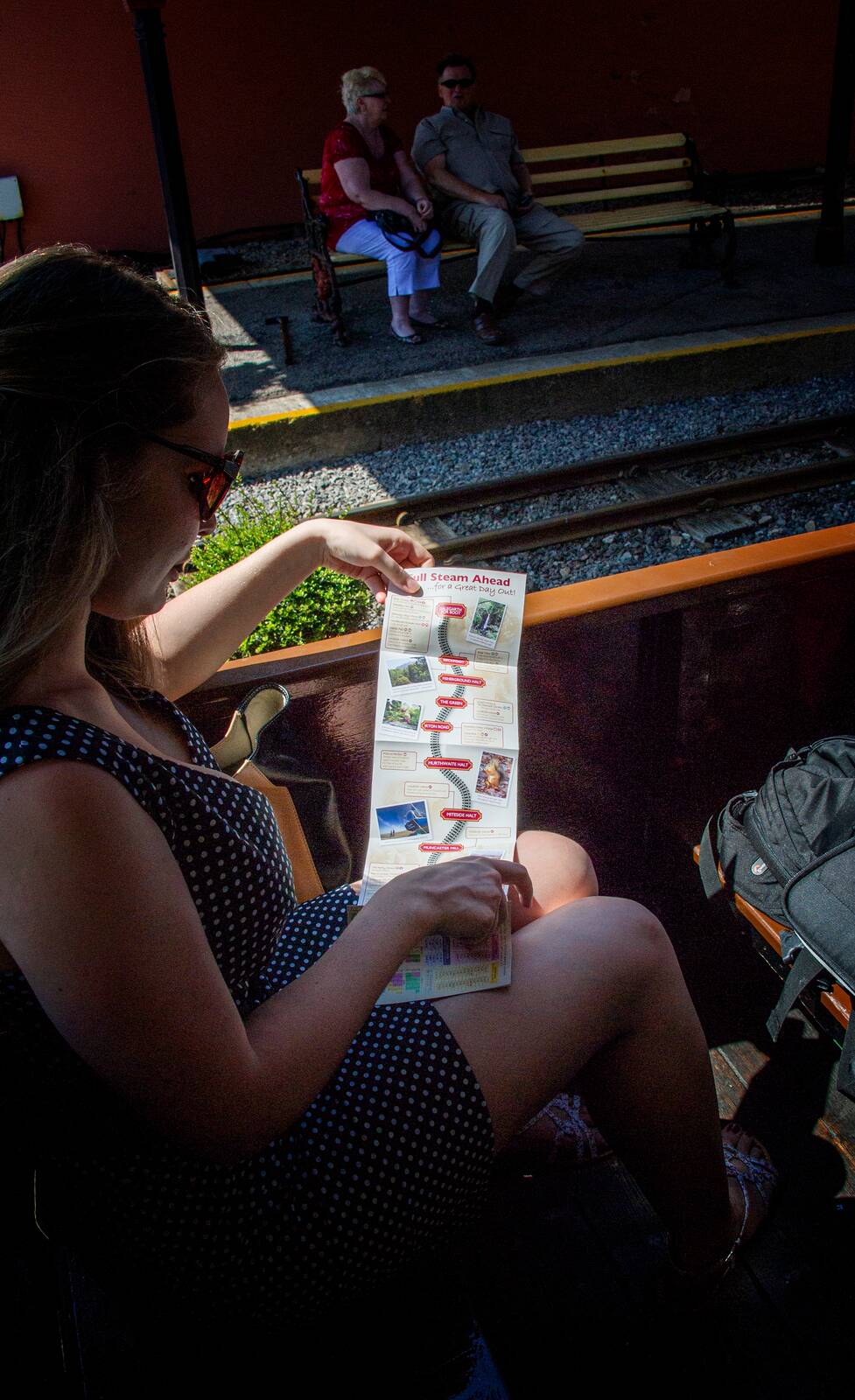 Passenger reading the railway leaflet