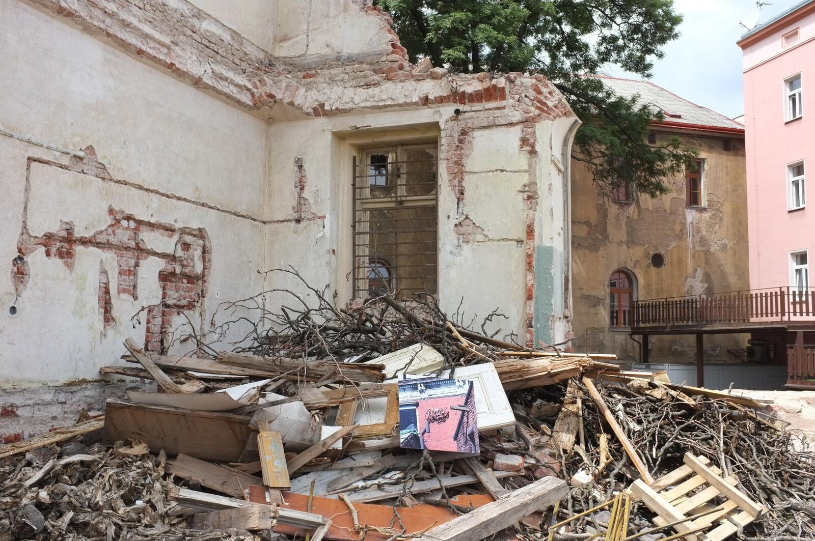 A print standing in the rubble of a demolished building