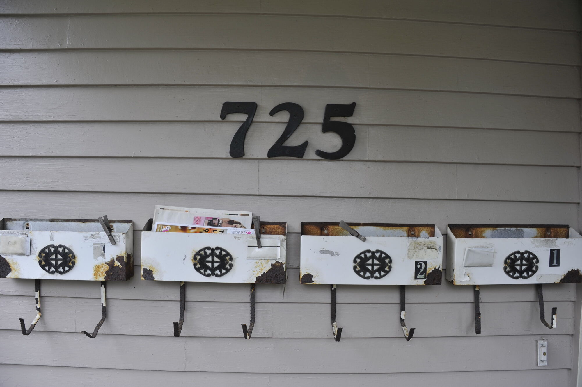 A row of painted mailboxes under the 725 numbers