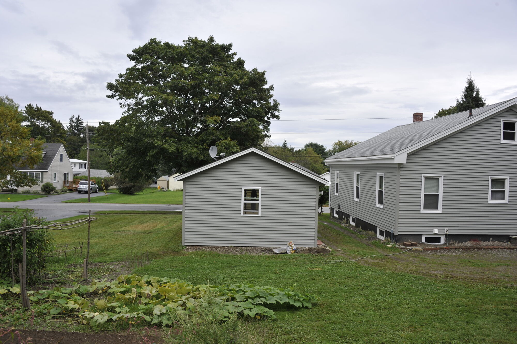 The back yard with garage and vegetable garden