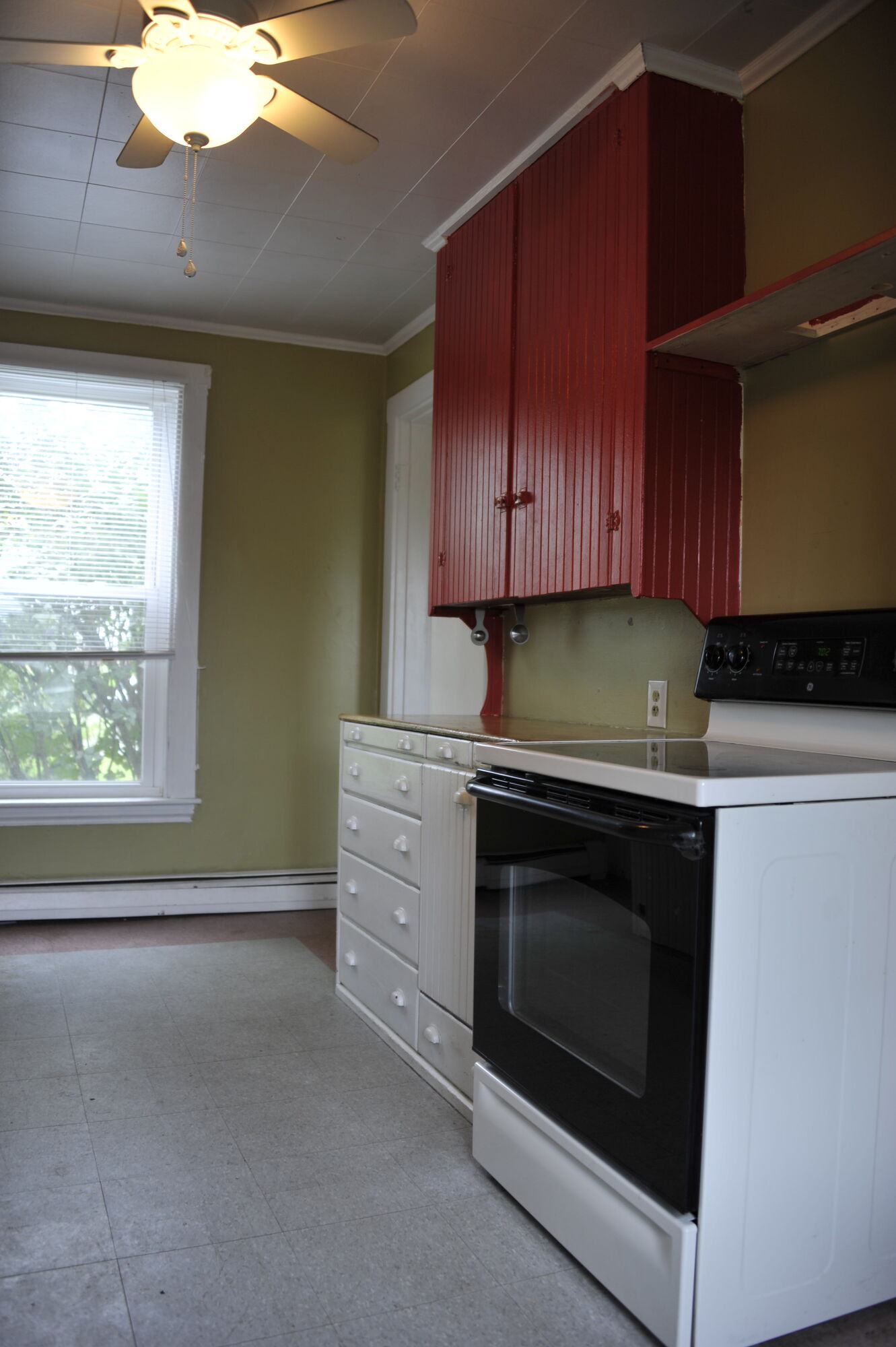 Red cabinets over the kitchen stove