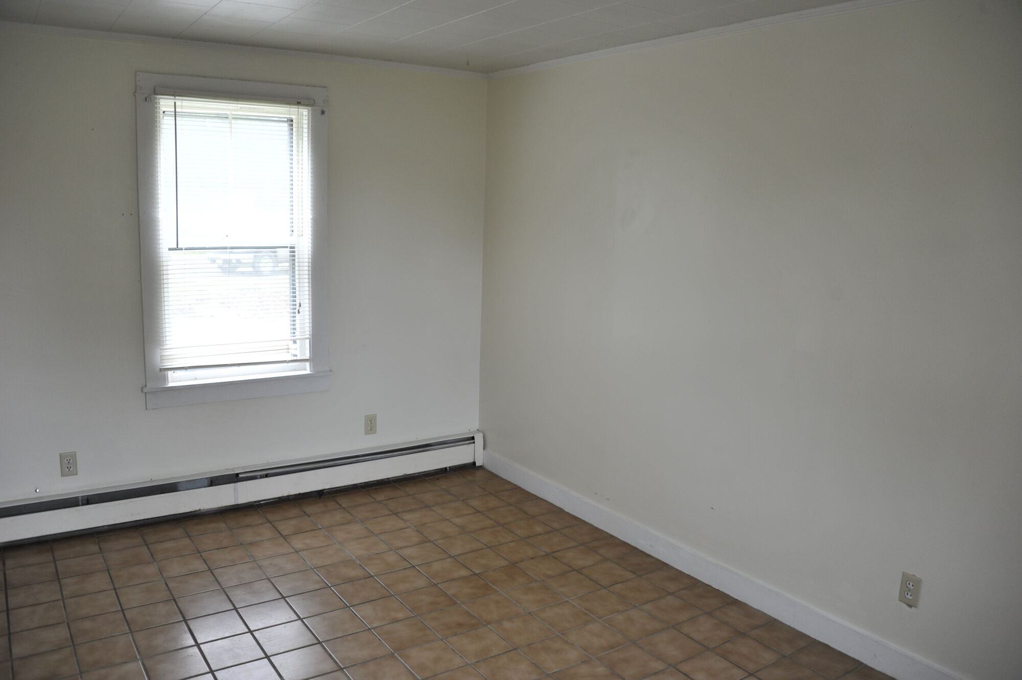 A bright empty room with a single window